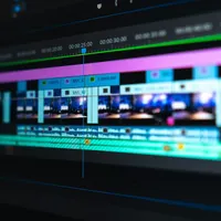A video edit timeline with coloured clips on a dark screen